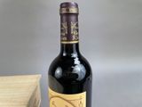 a bottle of wine sitting next to a wooden box