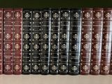 several books are lined up on a shelf in a row