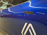 a close up of a blue car with a sticker on it