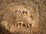 a close up of a metal object with writing on it