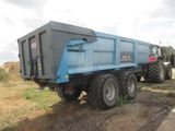 a blue dump truck parked on the side of the road