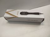 a box with a hair brush in it on a table