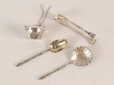 three spoons and two spoons sitting on a table