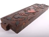 a close up of a wooden box with a flower design on it