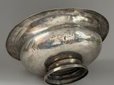 silver plated bowl on a white surface with a silver lid