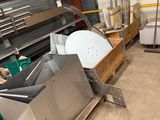 several pieces of metal are stacked on pallets in a warehouse