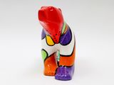 a colorful bear figurine on a white surface