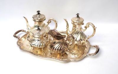 a silver tray with a silver tea set on it