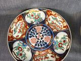 three plates are sitting on a table with a gray cloth