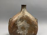 a brown vase that is sitting on a table