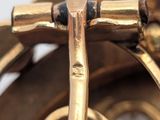 a close up of a gold colored object with a pair of scissors in it