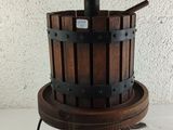 a wooden bucket with a metal handle on a stand