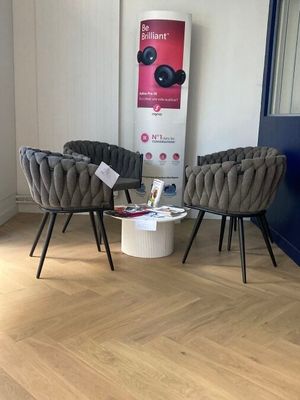 two chairs and a coffee table in the corner of a room