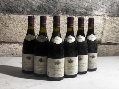 six bottles of wine are lined up in a row on a table