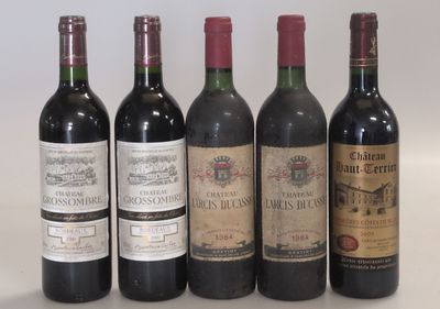 several bottles of wine are lined up on a white surface