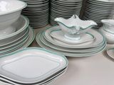 a lot of plates and bowls on the table