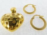 two pieces of jewelry including a heart shaped pendant, hoop earrings, and a ring