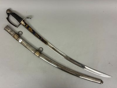 a pair of two swords on a table with a white background