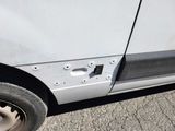 a close up of a car ' s side door with a hole in the side