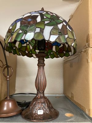 a lamp that is sitting on a shelf next to a lamp
