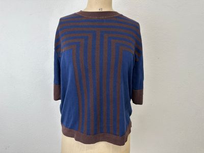 the top of a mannequin mannequin is wearing a blue and brown striped sweater