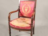 an old chair with a red and gold upholstered seat