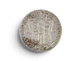 an old silver coin with a coat of arms on it
