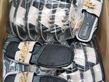 several pairs of sandals in a box on a table