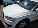 a picture of a white car parked in a parking lot