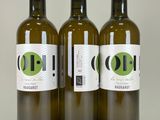 three bottles of olive oil sitting next to each other on a table