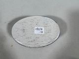 a white plate with a sticker on it sitting on a table
