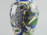 a blue and white vase with a floral design on it