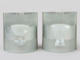two glass vases that are sitting on a table