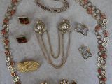 an assortment of jewelry including a necklace, bracelet, and brooches