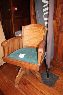 une chaise en bois sur laquelle est posé un parapluie, dans une pièce