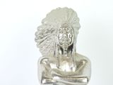 silver statue of a native american man with a feather headdress