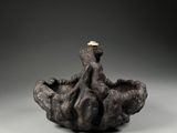 a close up of a sculpture of an octopus on a rock
