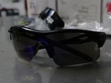 a pair of sunglasses sitting on a table next to a camera