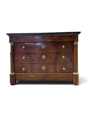 an antique chest of drawers with brass handles and a marble top
