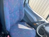 two seats in the back of a van with a steering wheel