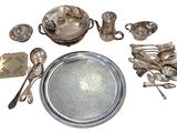 a silver plate with silver spoons and silverware on it