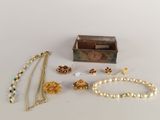 a box with a bunch of jewelry sitting on a table