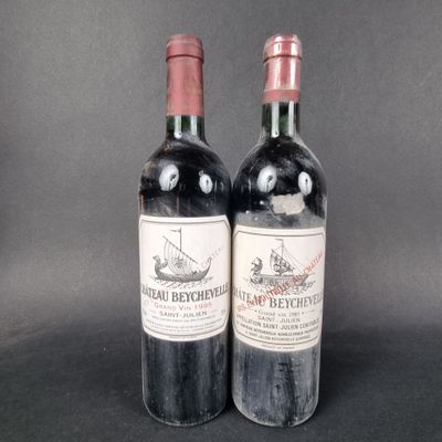 two bottles of red wine sitting next to each other on a table
