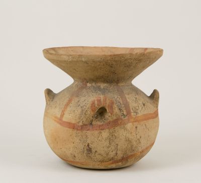 a brown vase with a design on it on a white surface