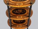 a three tiered table with a decorative design on it