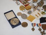 a table with a lot of medals and other items on it