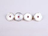 three silver and pink stone cufflinks on a white surface