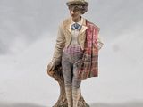 figurine of a man with a hat and a scarf