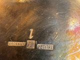 a close up of a silver plate with a cross on it
