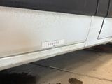 a picture of a dirty white truck parked in a garage